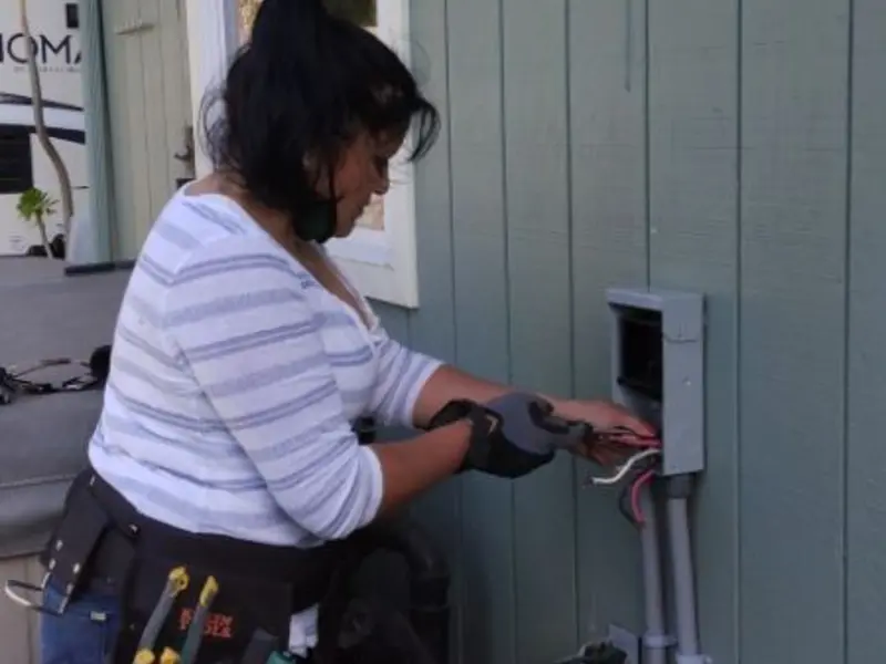 Licensed electrician wiring an exterior subpanel in Harrison
